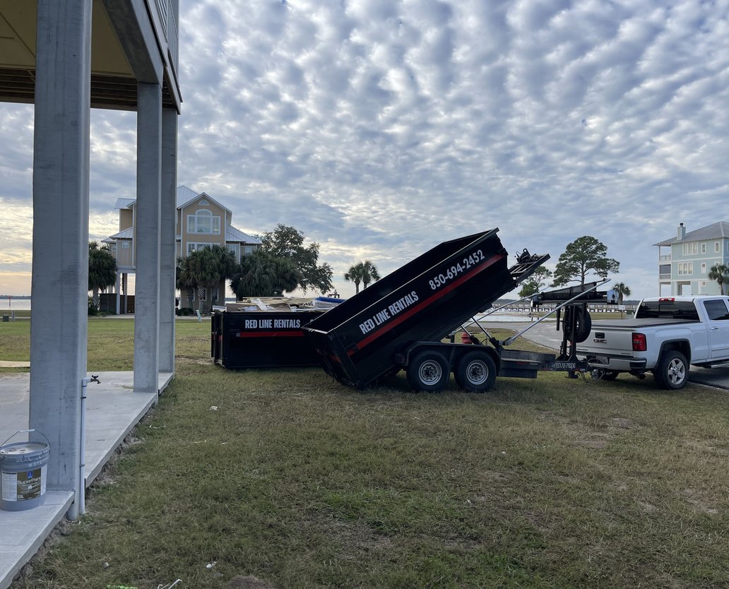 Red Line Rentals dump trailer hauling away construction debris